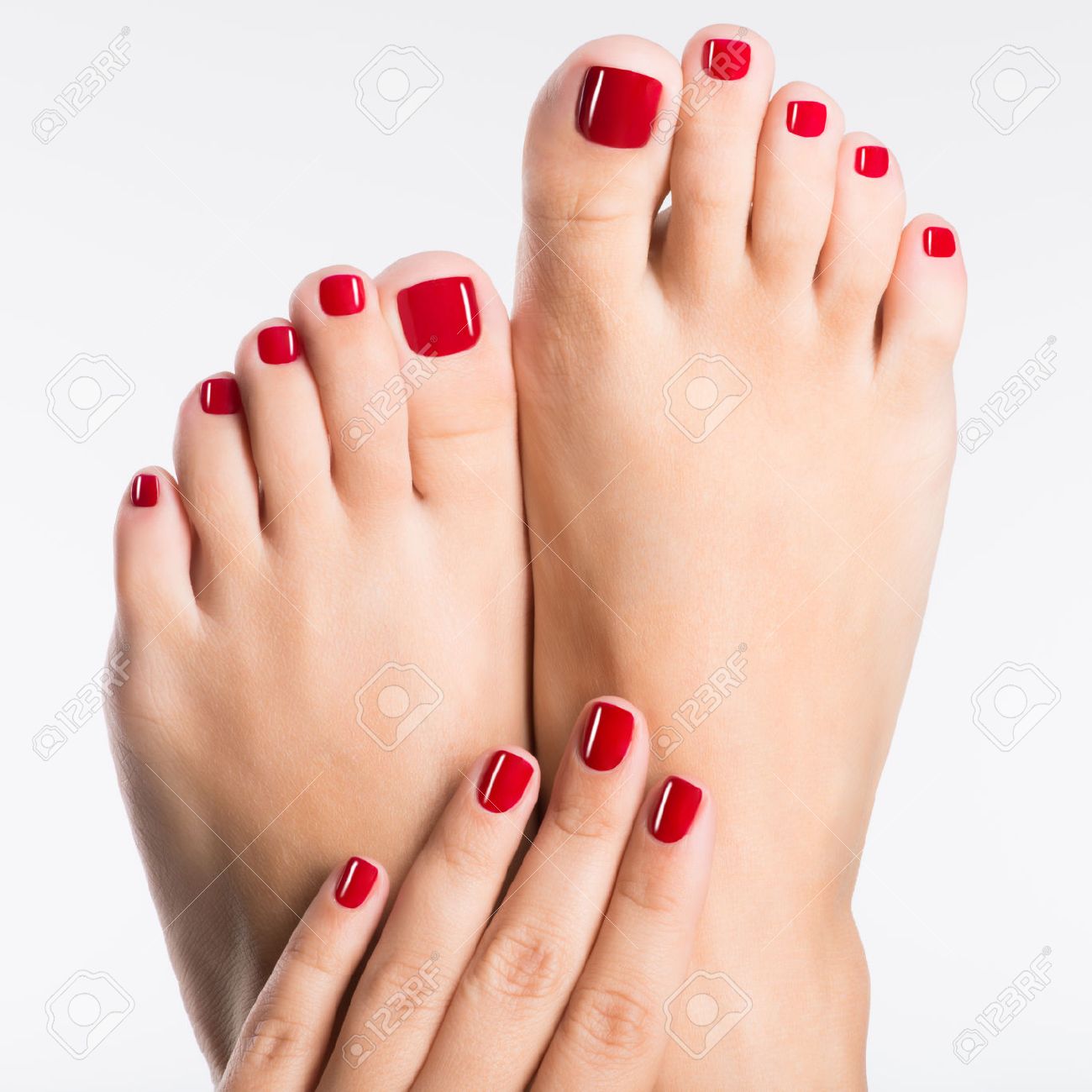 Closeup photo of a female feet with beautiful red pedicure over white background - 53558712 Closeup photo of a female feet with beautiful red pedicure over white background - 53558712