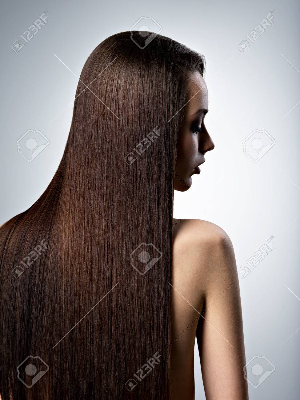 Portrait of beautiful woman with long straight brown hair at studio - 54099851 Portrait of beautiful woman with long straight brown hair at studio - 54099851