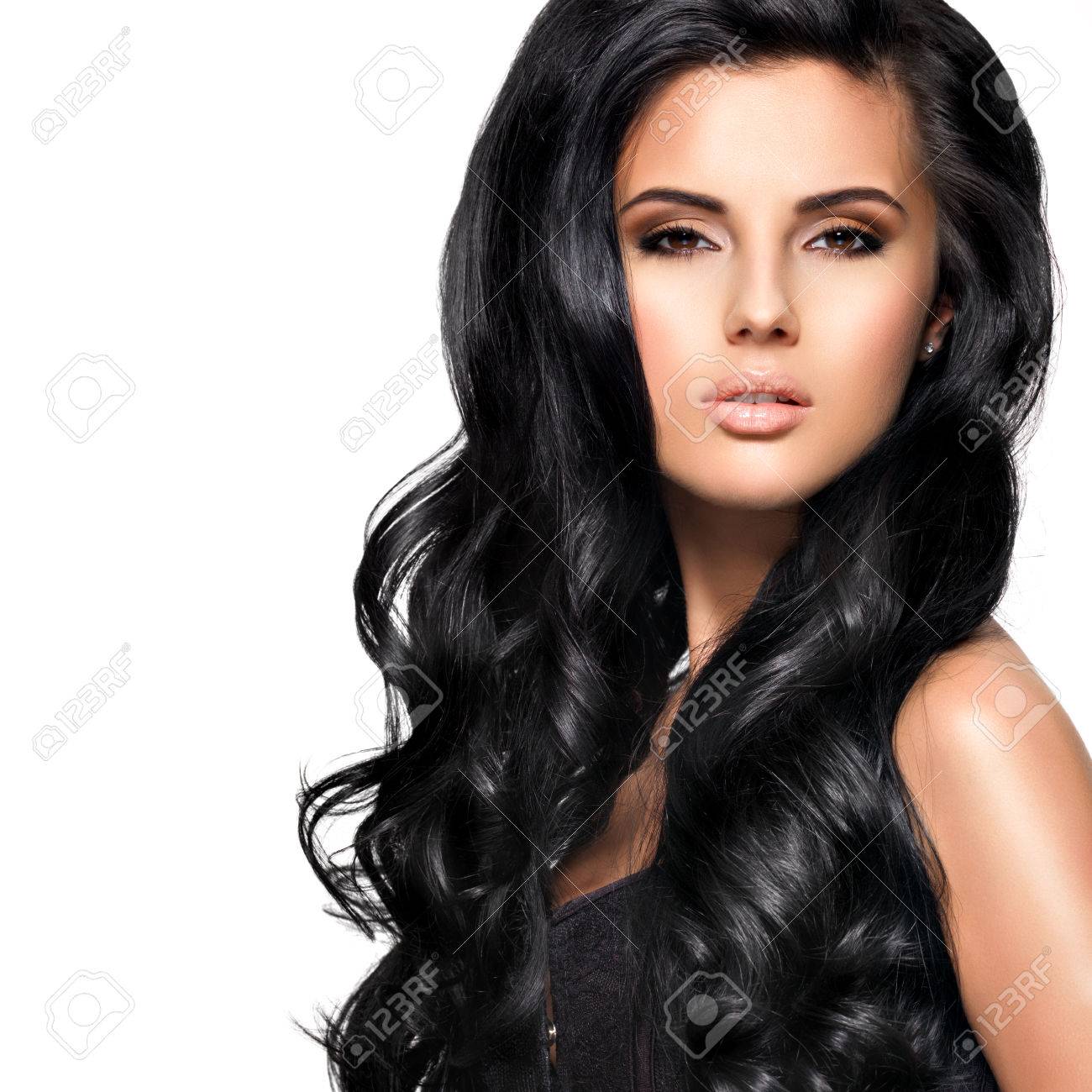 Beautiful young brunette woman with long black curly hair posing at studio - 54105052 Beautiful young brunette woman with long black curly hair posing at studio - 54105052