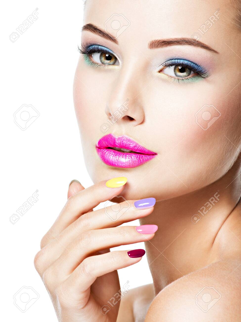 Close-up face of a beautiful woman with multicolor nails and fashion makeup . - 139390849 Close-up face of a beautiful woman with multicolor nails and fashion makeup . - 139390849
