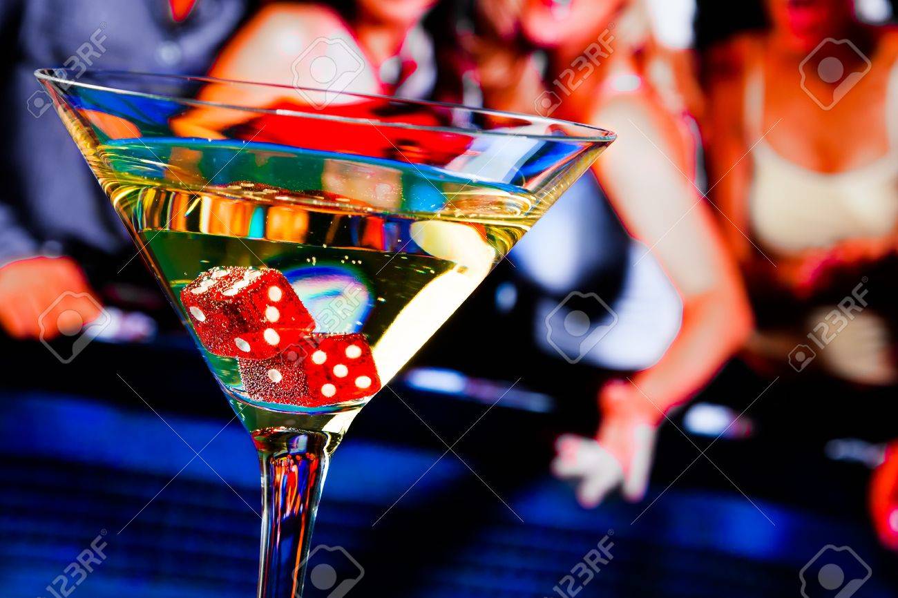 red dice in the cocktail glass in front of gambling table, casino series - 32455745 red dice in the cocktail glass in front of gambling table, casino series - 32455745