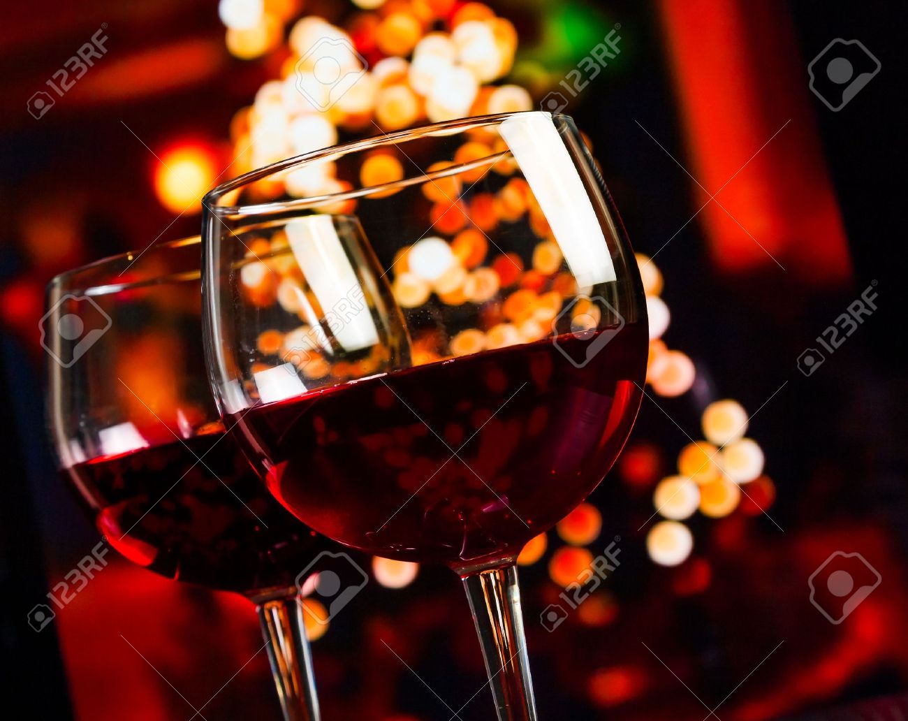 two red wine glass against christmas lights decoration background, christmas atmosphere - 33524423 two red wine glass against christmas lights decoration background, christmas atmosphere - 33524423