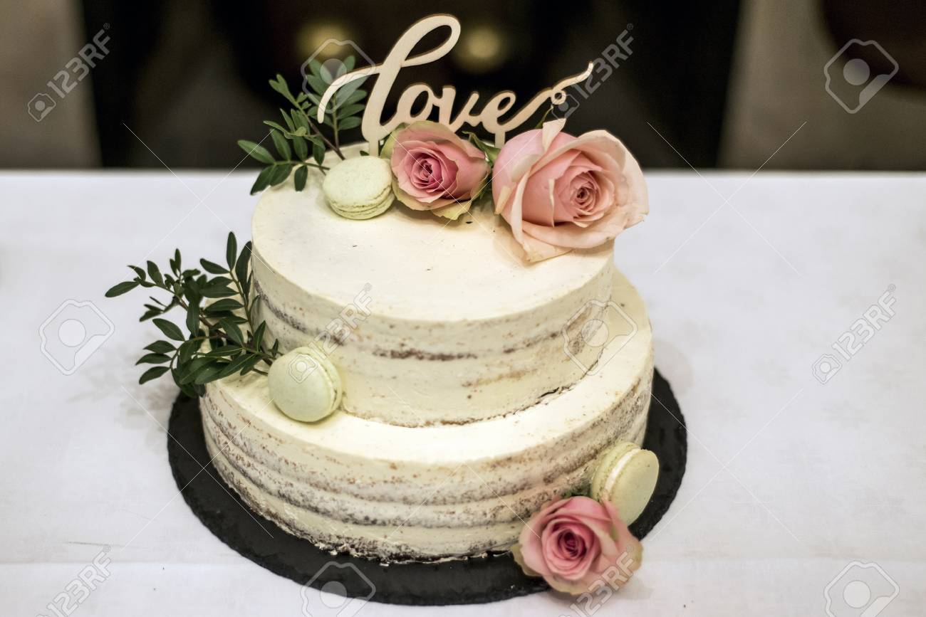 Beautiful Wedding Cake With Cream With Text Love On Top And Pink