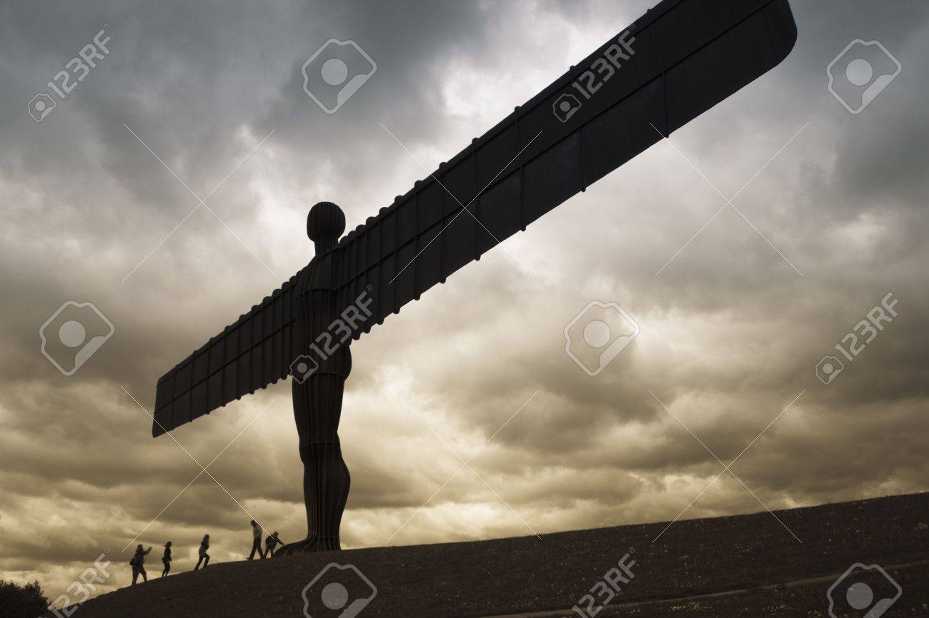 tourists climbing the slope in front of the massive steel sculpture steelsculpture