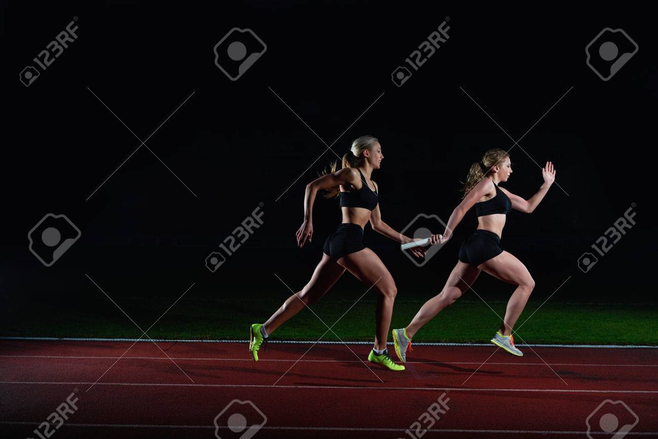 Woman Athletic Runners Passing Baton In Relay Race Stock Photo Picture And Royalty Free Image Image