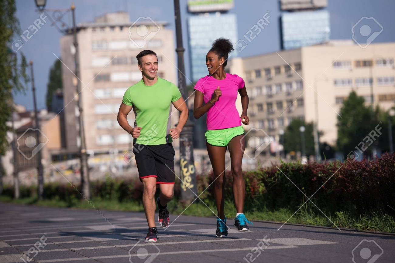 healthy young multiethnic couple jogging in the city on a sunny summer day - 67136460 healthy young multiethnic couple jogging in the city on a sunny summer day - 67136460