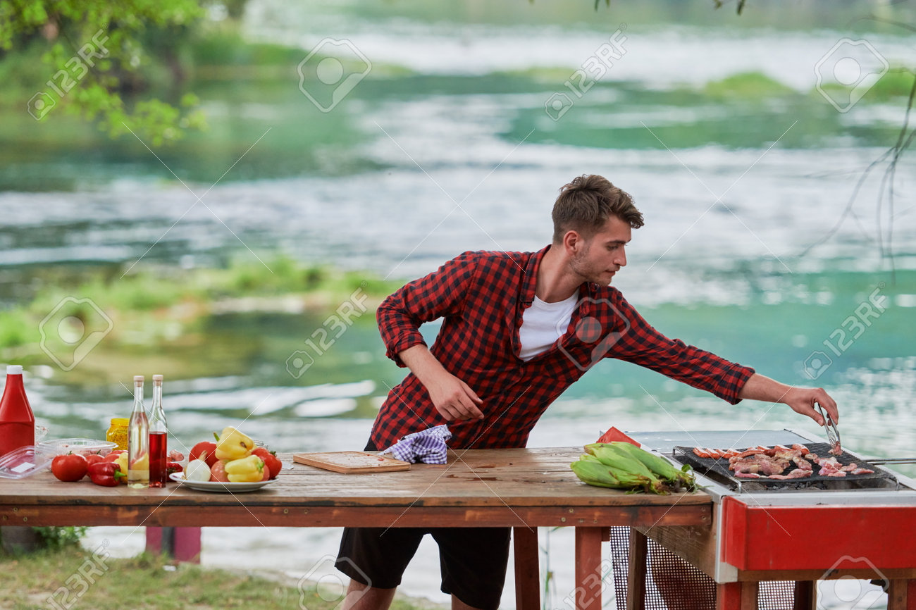 man putting spices on raw meat for barbecue - 166310756 man putting spices on raw meat for barbecue - 166310756