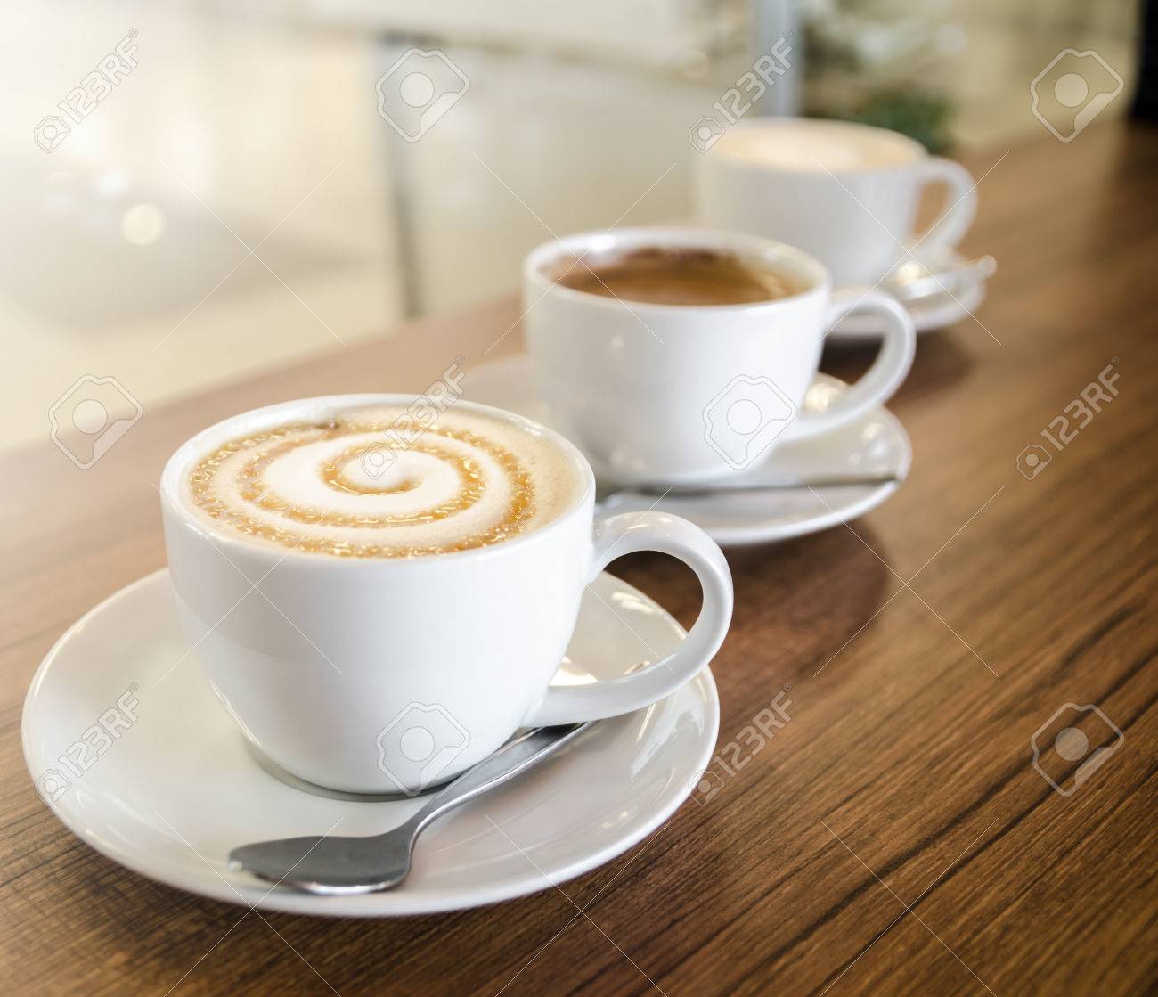 Three Coffee Cups With Cappuccino Caramel Macchiato Latte Stock Three Coffee Cups With Cappuccino Caramel Macchiato Latte Stock