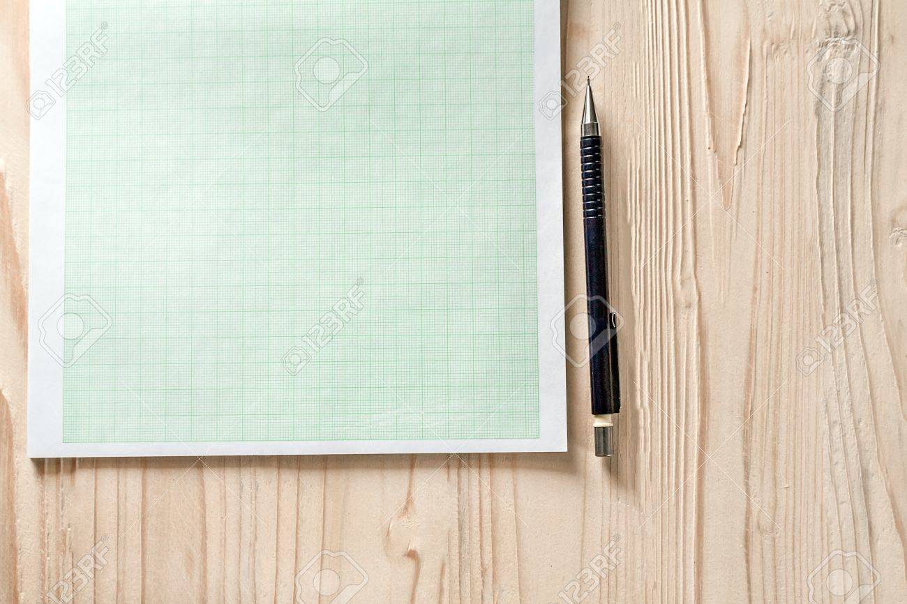 close up blank graph paper on wooden desk with copy space for