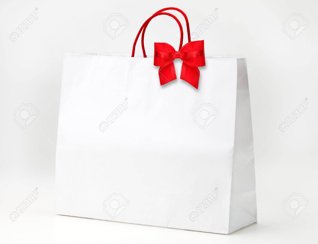 White Shopping Bag With Red Bow On White Stock Photo Picture And