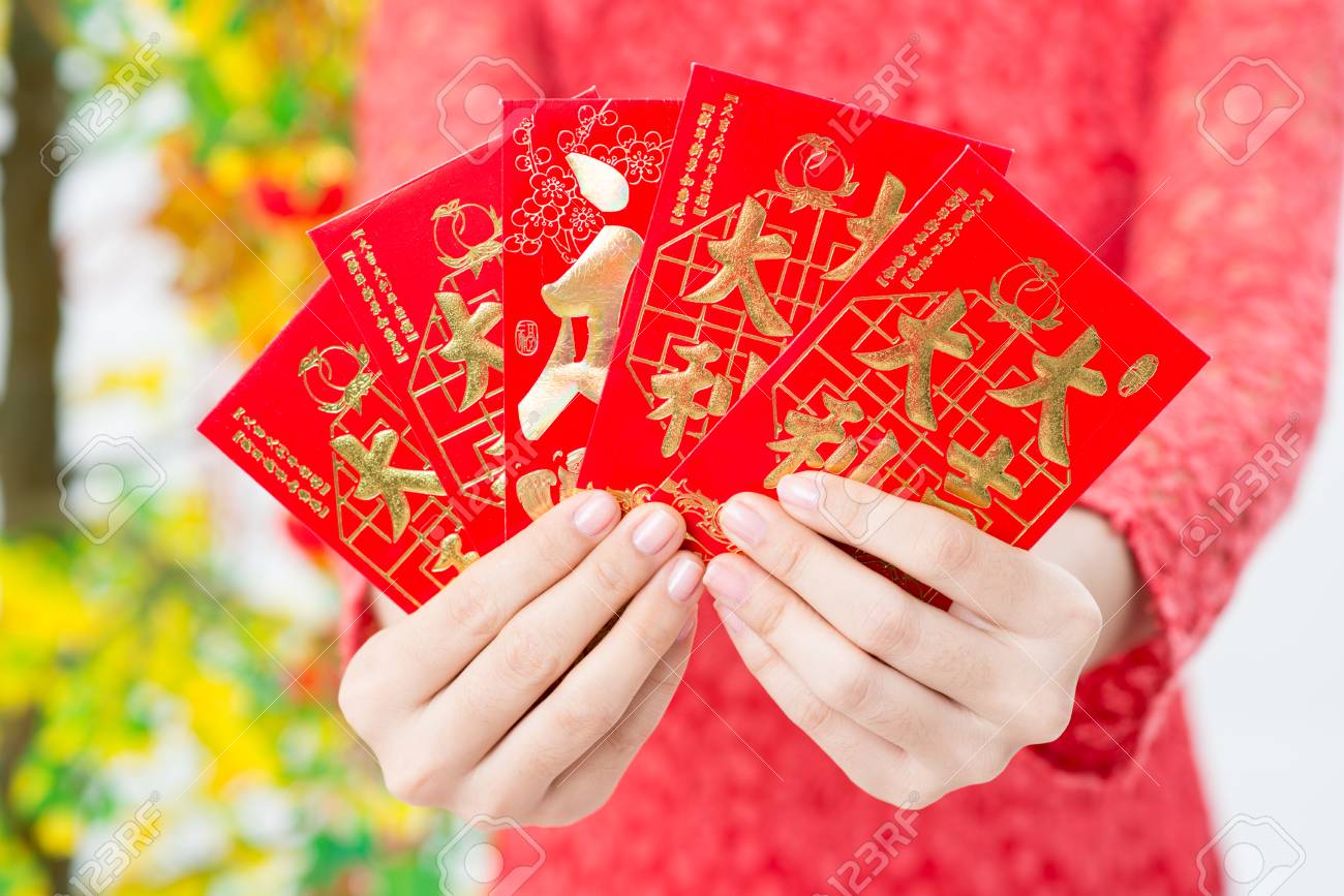 Close-up Of Vietnamese Red Envelopes With Money Being Presented On