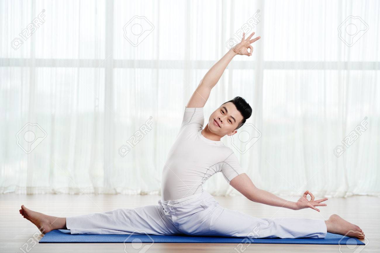 Smiling Handsome Asian Man Doing Splits On Yoga Mat Stock Photo, Picture  and Royalty Free Image. Image 73794074.