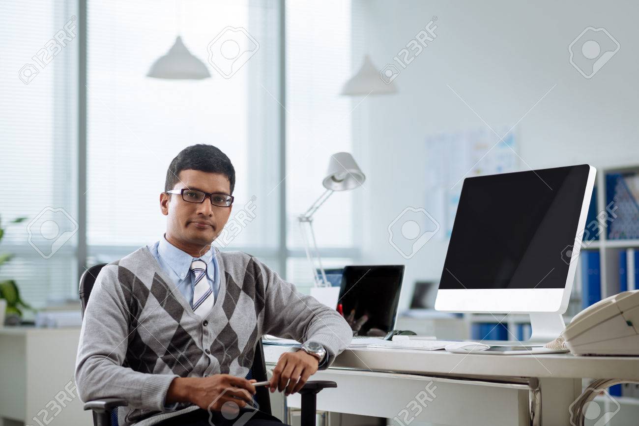 Portrait Of Confident Indian Programmer At His Workplace Stock Photo, Picture And Royalty Free Image. Image 74810023.