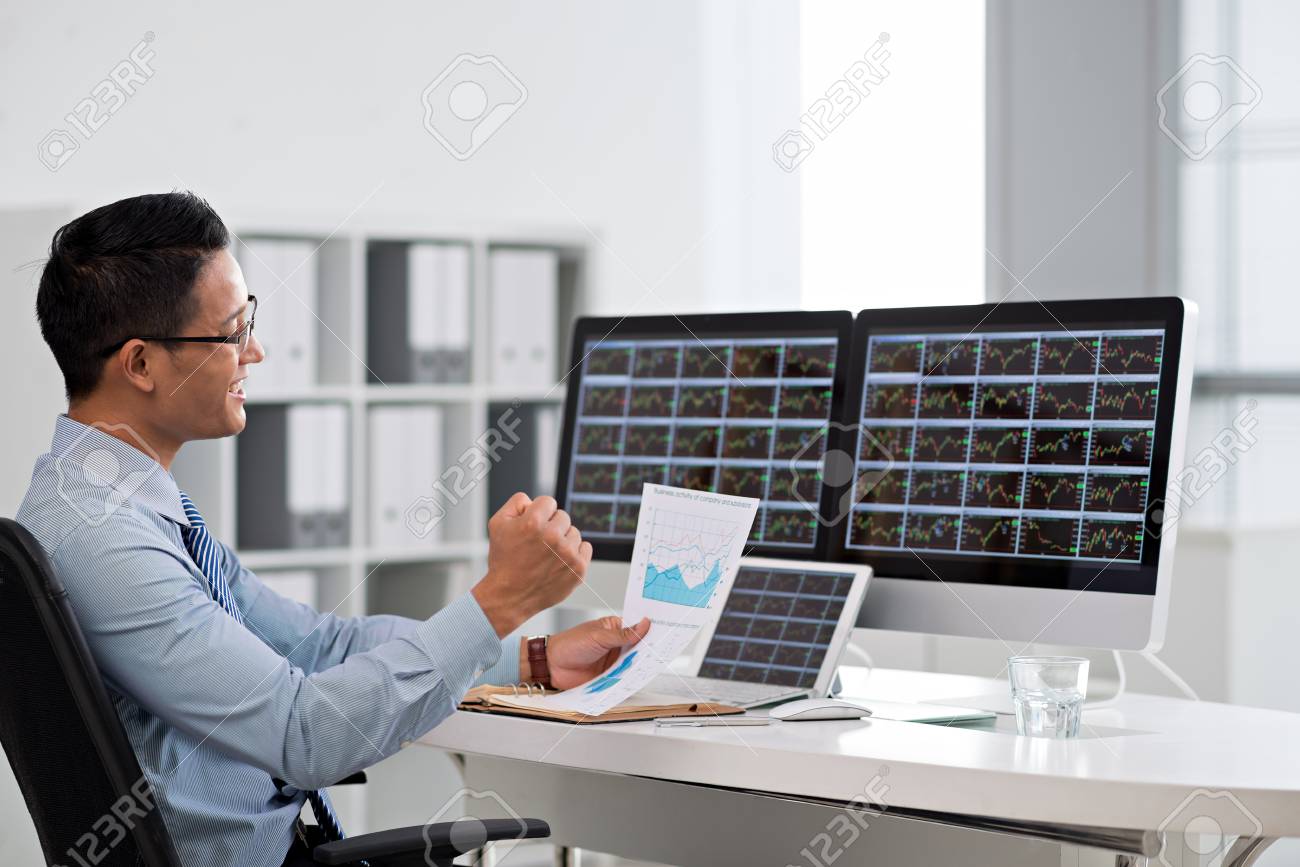 Happy Excited Financial Broker Looking At The Business Chart Stock Photo Picture And Royalty Free Image Image