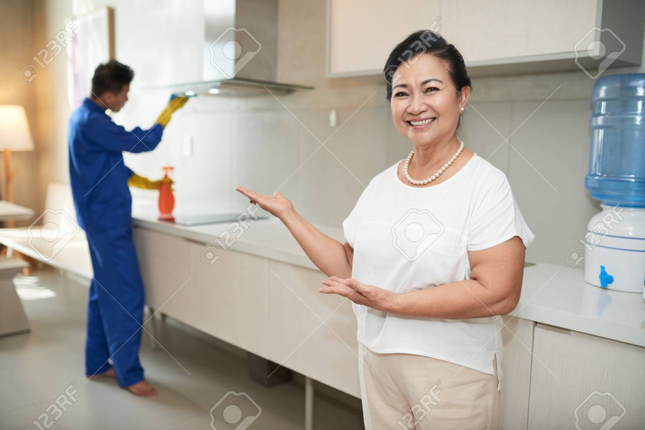 Cheerful Housewife And Plumber Stock image