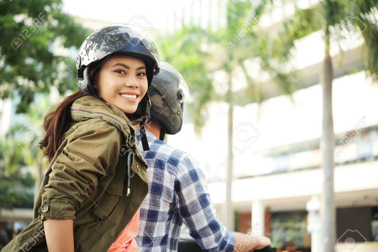 Young woman enjoyng bike ride - 104152081 Young woman enjoyng bike ride - 104152081