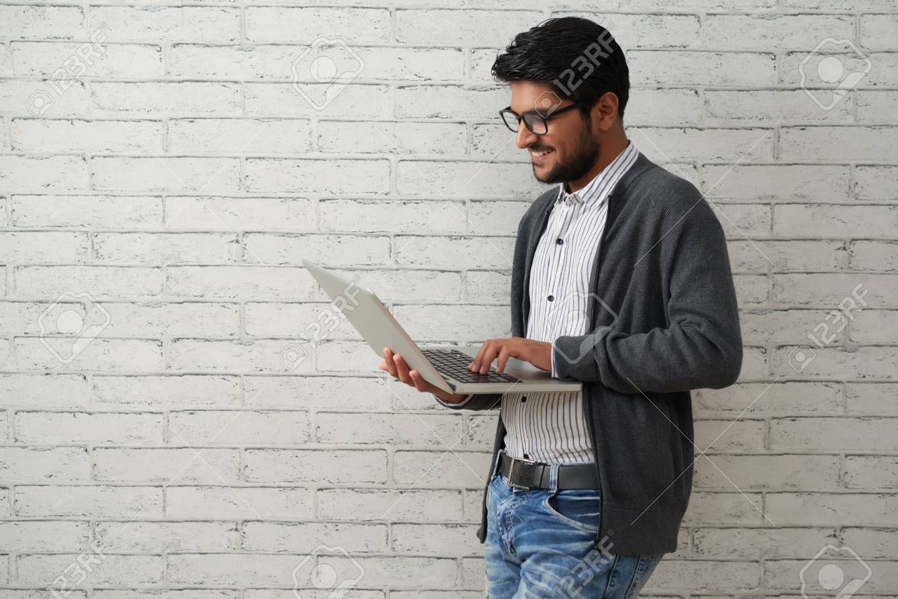 Cheerful programmer with laptop - 118147549 Cheerful programmer with laptop - 118147549