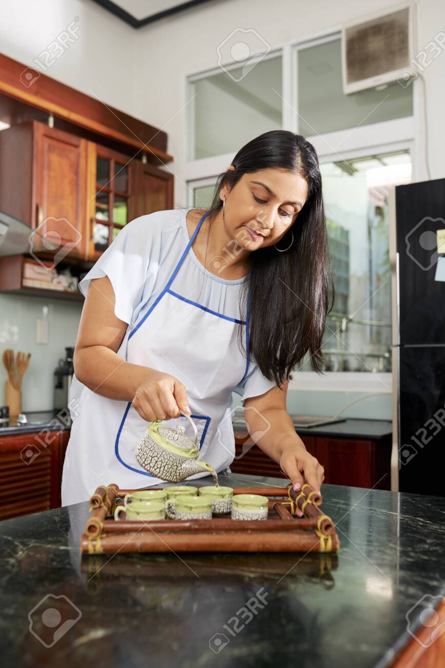 Indian Woman Filling Cups With