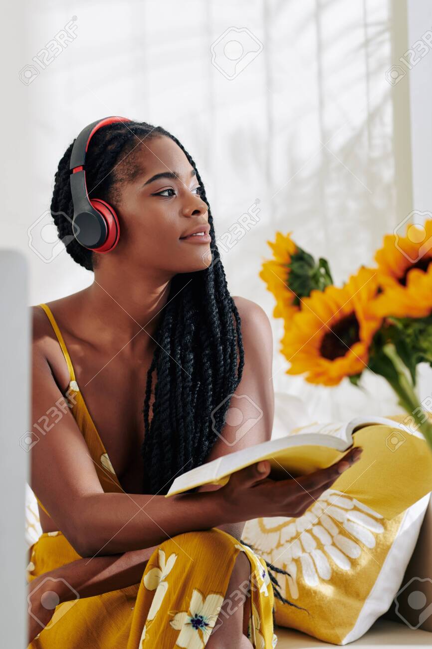 Pretty Young Black Woman Listening To Music When Studying At Home And  Reading A Book Stock Photo, Picture and Royalty Free Image. Image 139565532., image size:866x1300