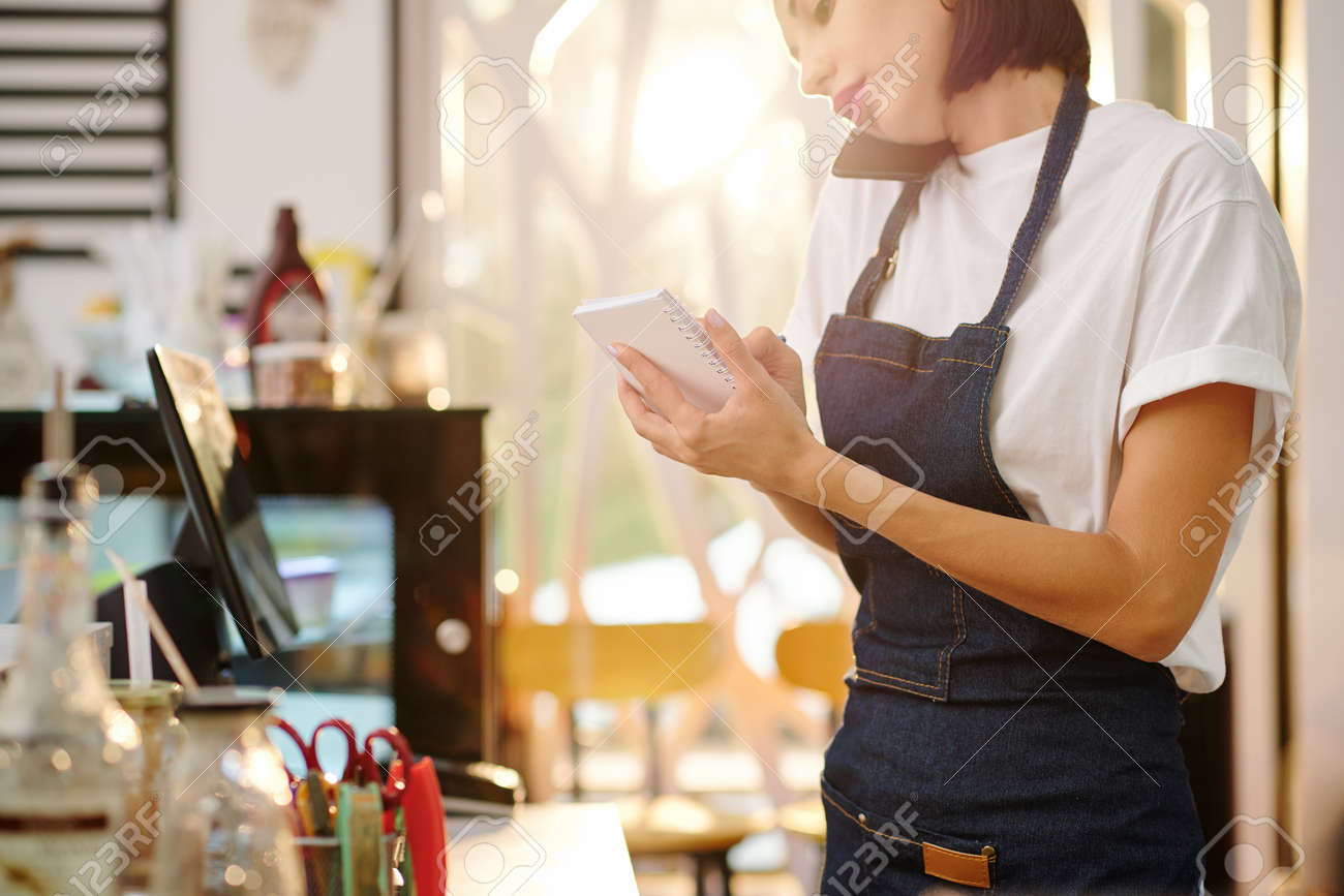 Waitress accepting order on phone - 159127823 Waitress accepting order on phone - 159127823
