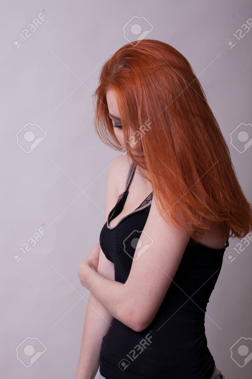 Beautiful Busty Redhead Woman In Studio Photo On Gray Background Sexuality And Sensuality Attractive Beautiful Busty Redhead Woman In Studio Photo On Gray Background Sexuality And Sensuality Attractive