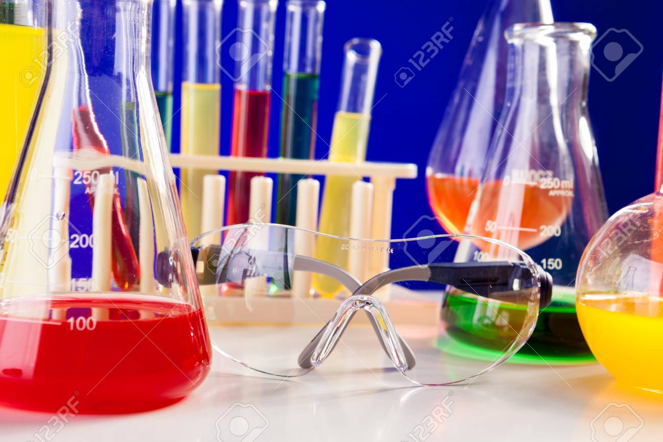 chemistry lab set with colored chemicals in it on a table over chimistry lab