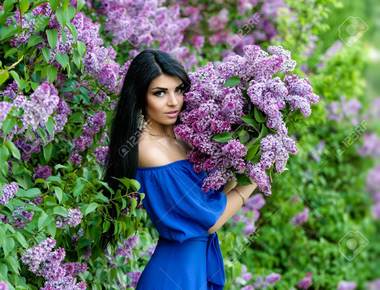 Beautiful Smiling Young Woman With Lilac Flowers Bouquet In Hands Stock Photo Picture And Royalty Free Image Image 51844728