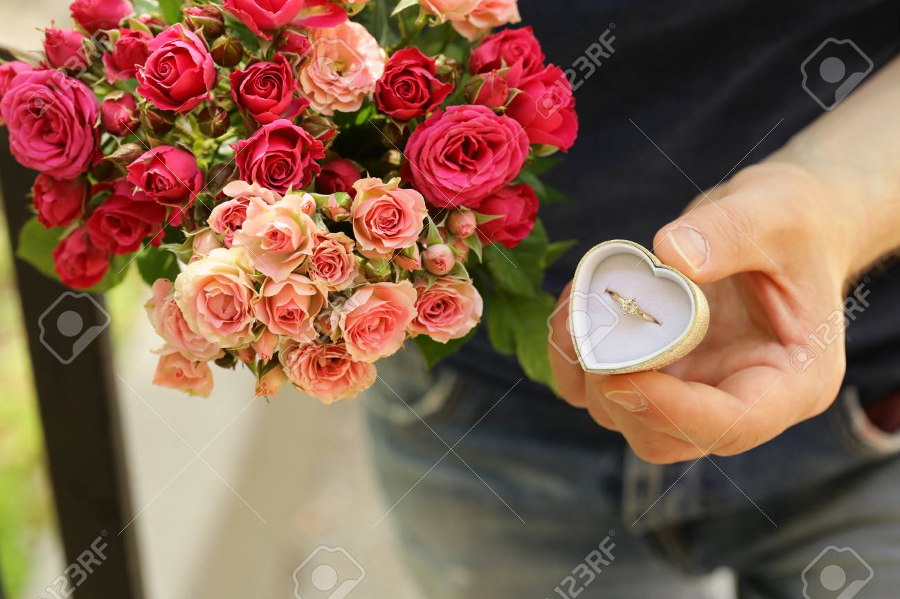 Man With A Bouquet Of Roses And A Diamond Ring, Ready To Make ...
