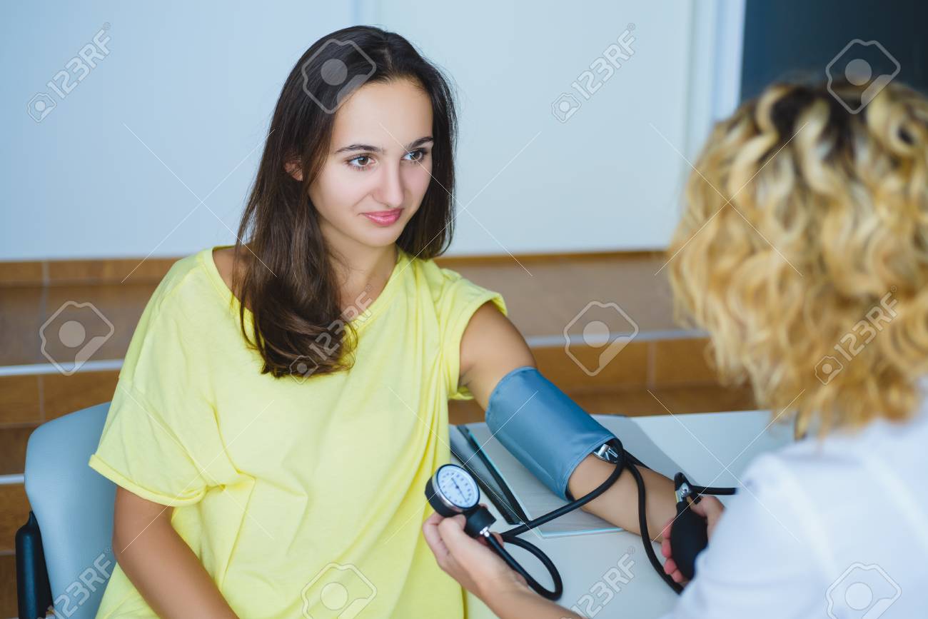 Female Doctor Checking Young Woman 