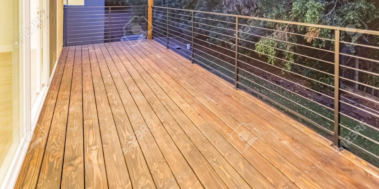 Balcony With Wooden Floor And Glass Door Access Stock Photo