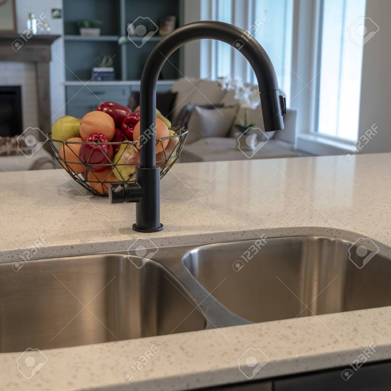 Square Kitchen Island Of Home With Double Basin Undermount Sink Stock Photo