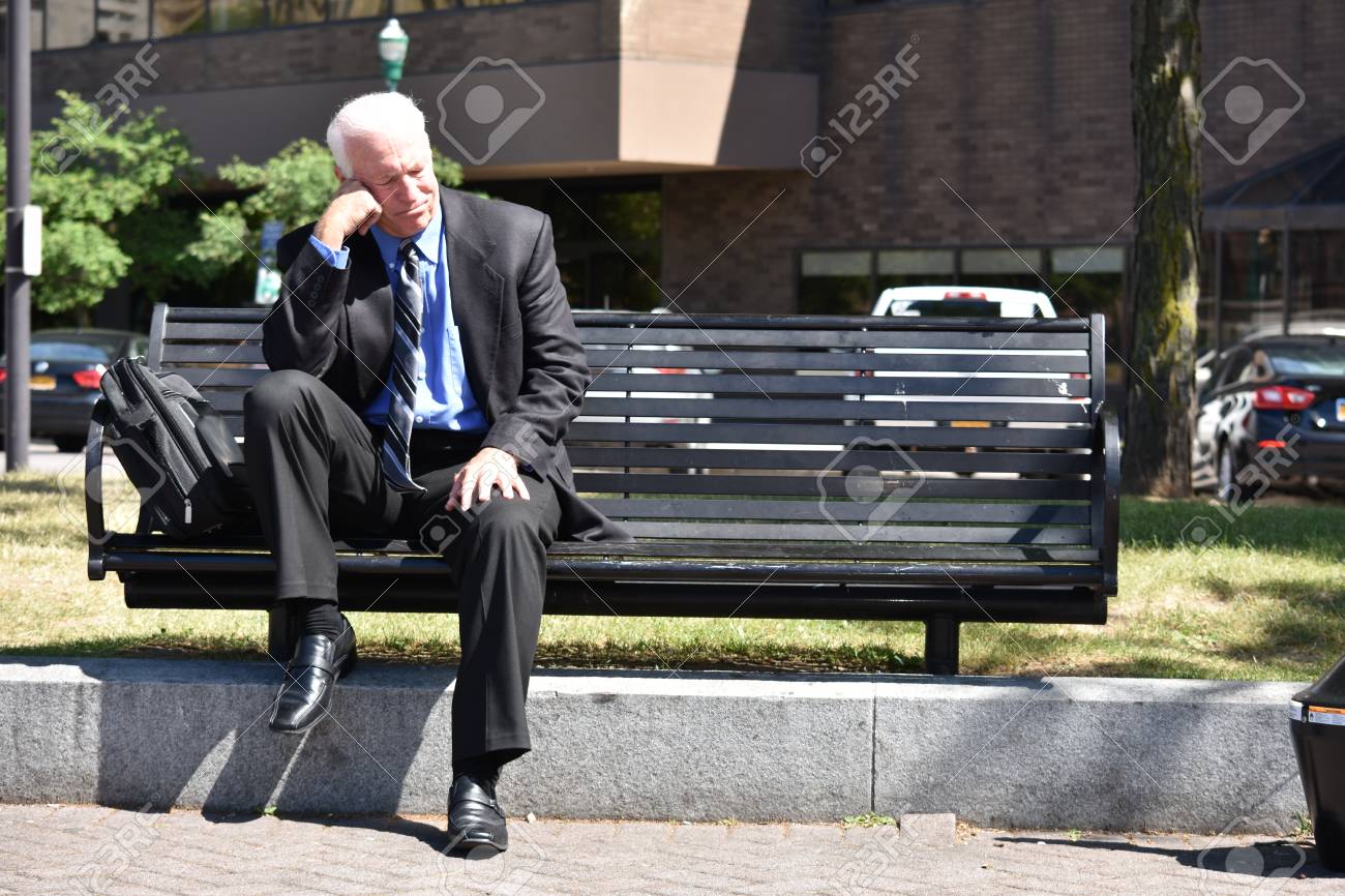 Sad Business Man Wearing Suit Sitting On Bench Stock Photo