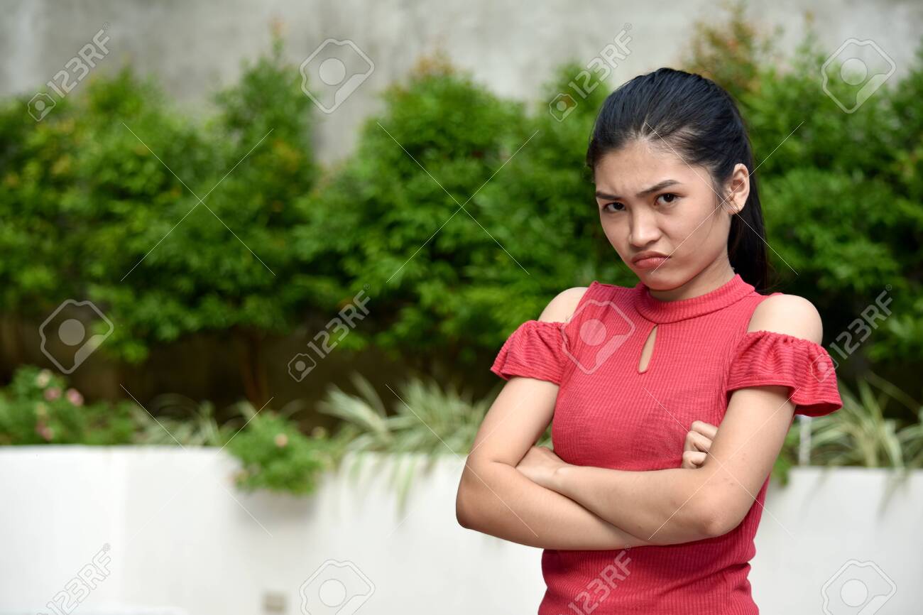 A Stubborn Beautiful Minority Teenager Girl Stock Photo, Picture and  Royalty Free Image. Image 131154208.