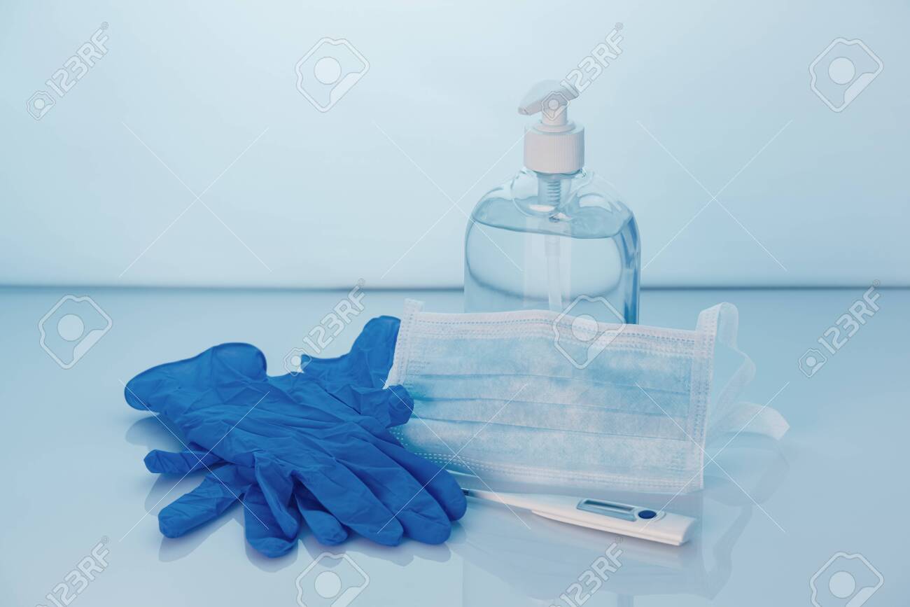 Coronavirus prevention set, hand sanitizer gel, protective mask, gloves and thermometer. COVID-19 concept. Health protection. Copy space. - 143770326 Coronavirus prevention set, hand sanitizer gel, protective mask, gloves and thermometer. COVID-19 concept. Health protection. Copy space. - 143770326