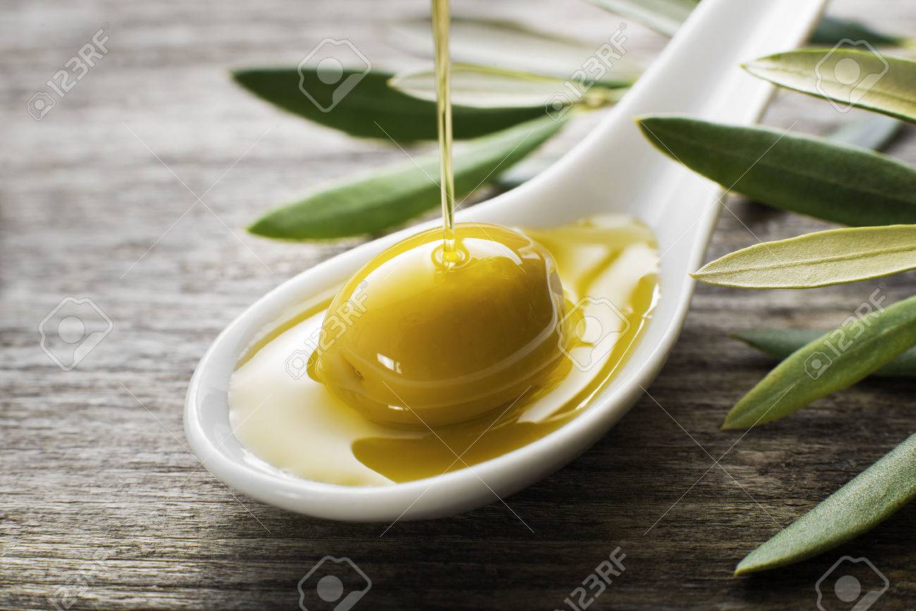 Olive oil pouring on the spoon close up - 36811062 Olive oil pouring on the spoon close up - 36811062