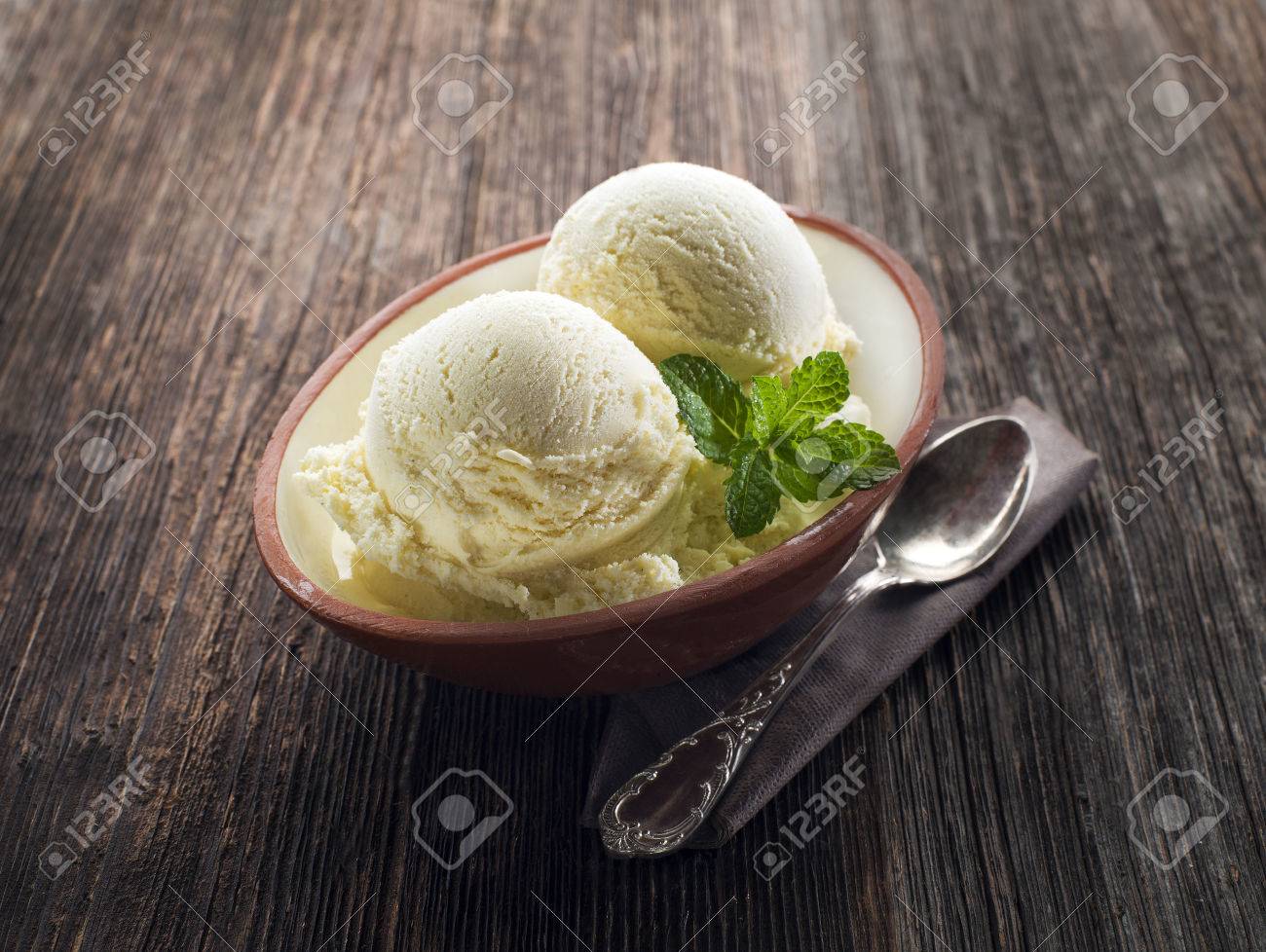 Vanilla Ice cream on a wooden background close up - 42643759 Vanilla Ice cream on a wooden background close up - 42643759