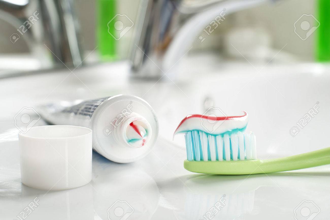 Toothbrush and toothpaste in the bathroom close up. - 54345994 Toothbrush and toothpaste in the bathroom close up. - 54345994