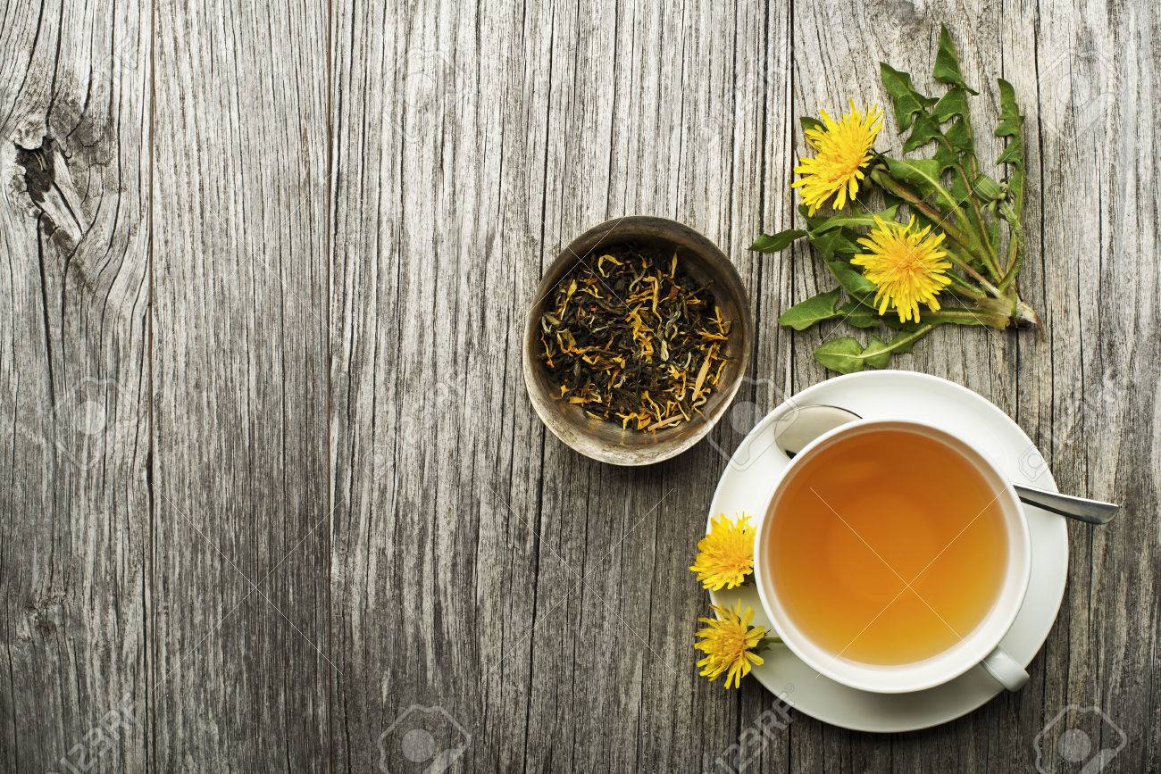 Cup of healthy dandelion tea on wooden background. Herbal medicine. - 76462549 Cup of healthy dandelion tea on wooden background. Herbal medicine. - 76462549