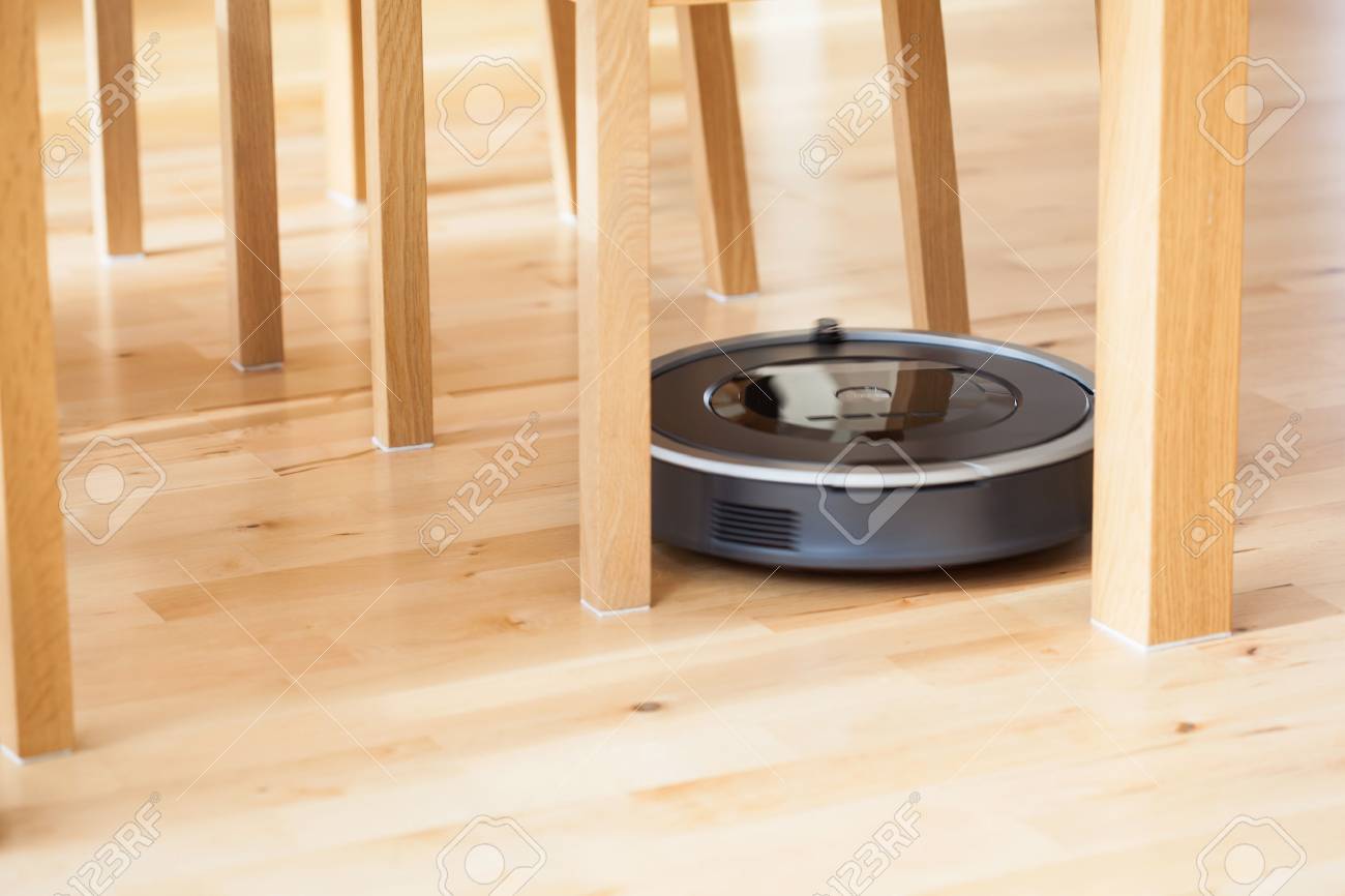 Robotic Vacuum Cleaner On Laminate Wood Floor Smart Cleaning