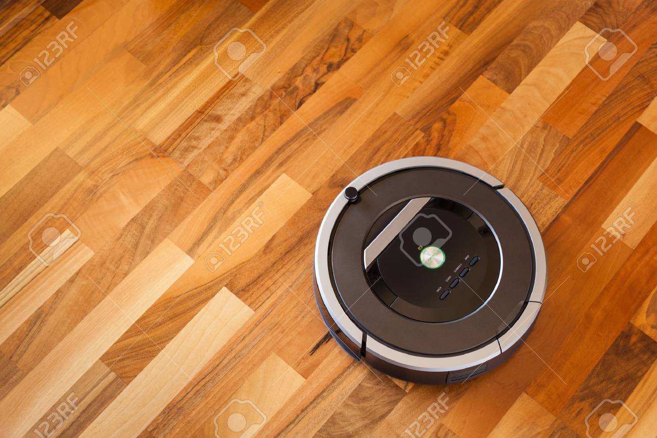 Robotic Vacuum Cleaner On Laminate Wood Floor Smart Cleaning