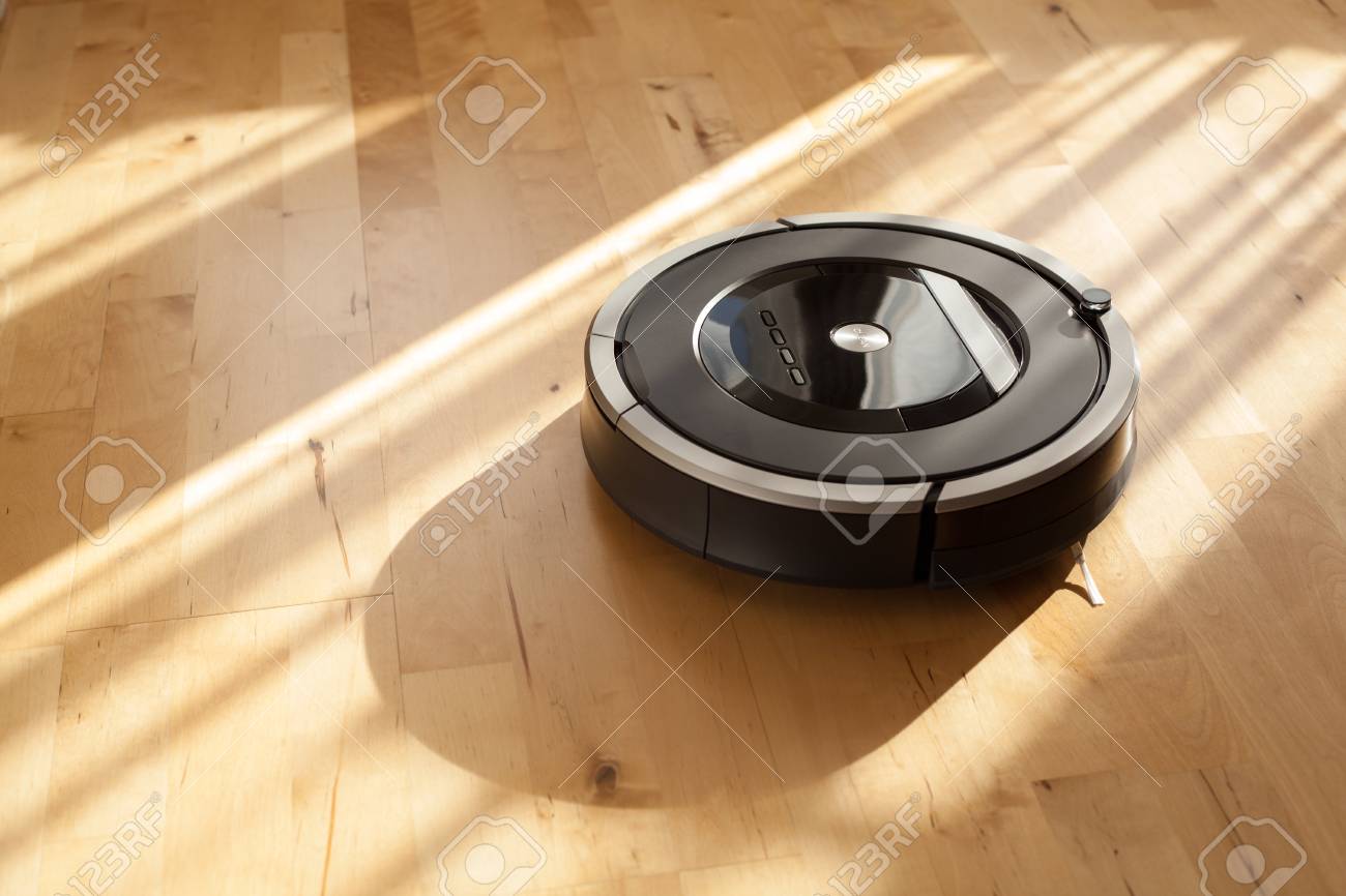 Robotic Vacuum Cleaner On Laminate Wood Floor Smart Cleaning