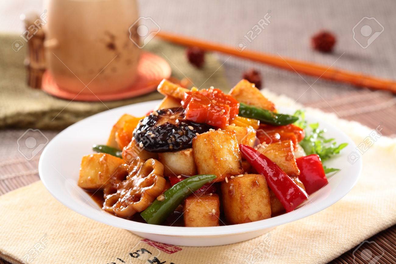 Lotus root simmered tofu with mushroom, chili and sliced lotus on white plate - 63055739 Lotus root simmered tofu with mushroom, chili and sliced lotus on white plate - 63055739