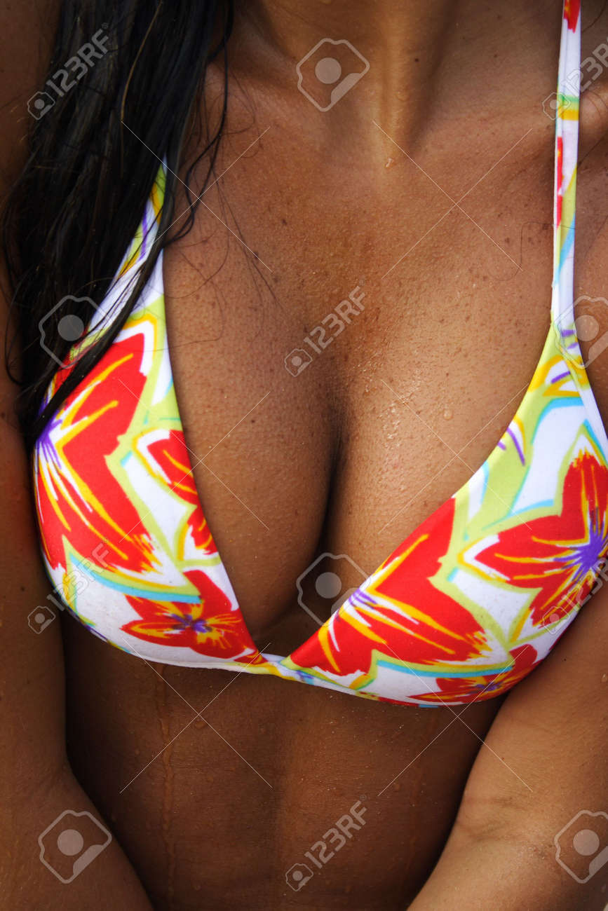 A Sexy Tanned Girl's Breasts Wearing A Flowered Bikini At The Beach. Stock  Photo, Picture and Royalty Free Image. Image 5222250.