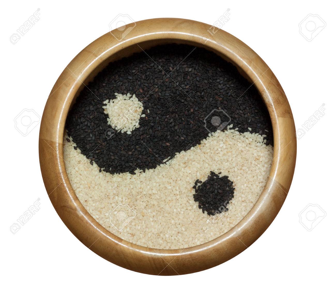 yin yang black and white sesame in wooden bowl isolated on white