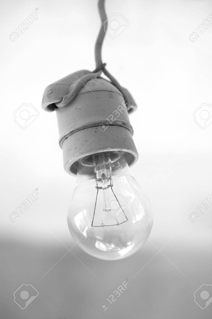 Turning Off An Electric Light Bulb In Ceramic Holder Hanging Turning Off An Electric Light Bulb In Ceramic Holder Hanging