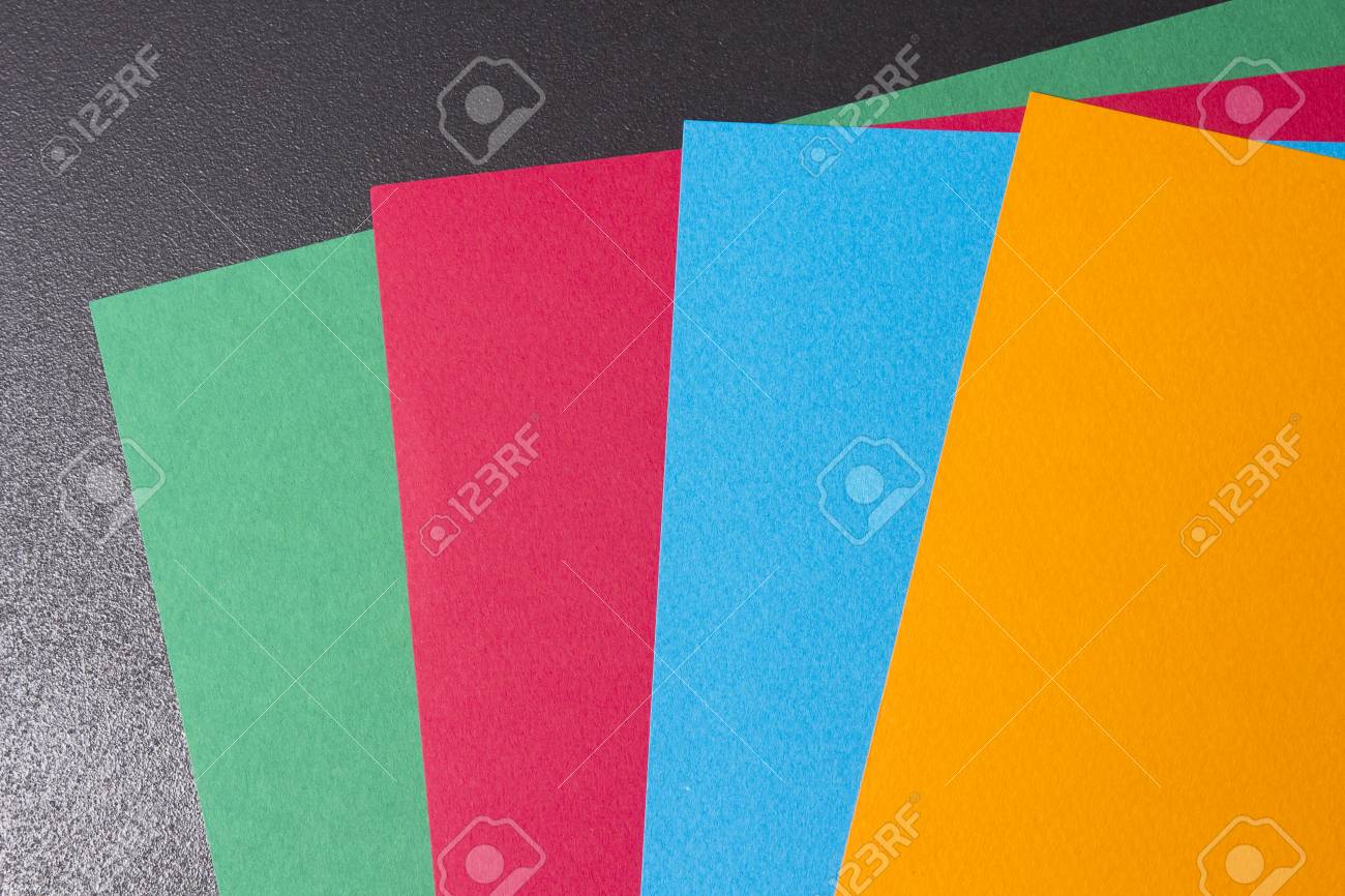 multi colored sheets of paper on a black background sheets of multi colored sheets