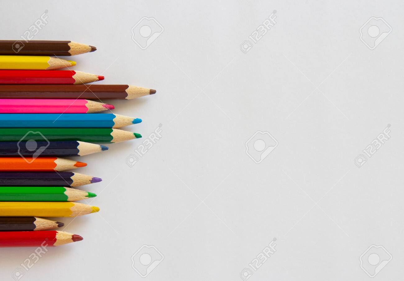 Multi-colored markers and pencils on a white background. School supplies .copyspace for text. - 143556781 Multi-colored markers and pencils on a white background. School supplies .copyspace for text. - 143556781