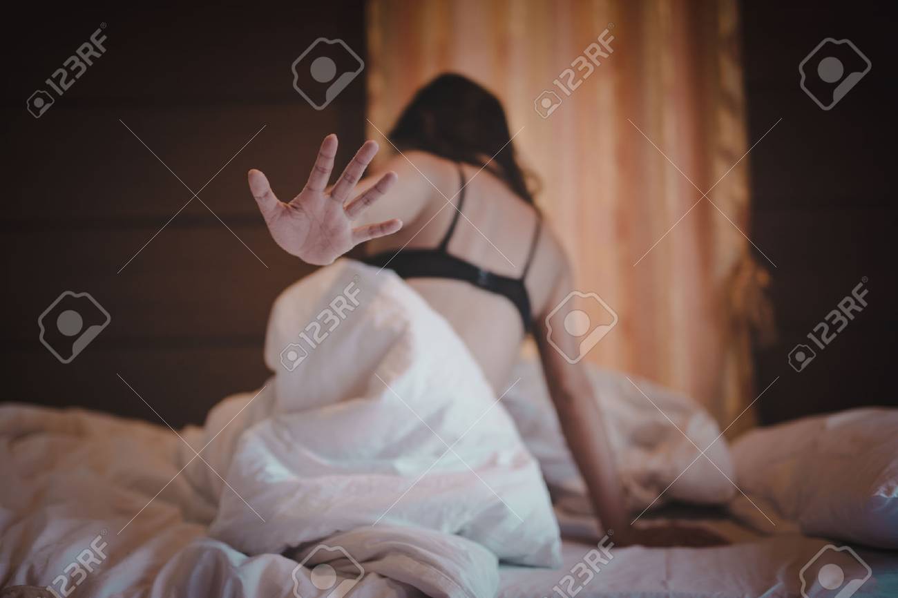 woman sit on a bed in a bedroom - concept photo of Sexual assault - 77518014 woman sit on a bed in a bedroom - concept photo of Sexual assault - 77518014