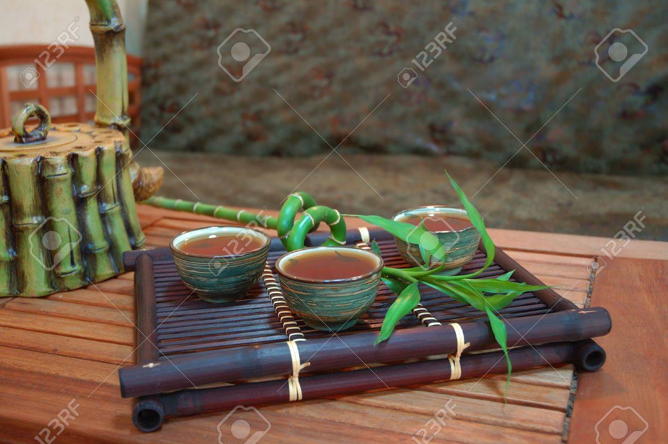 chinese tea in antique bowls with bamboo and teapot. interior chinese tea in antique bowls with bamboo and teapot. interior