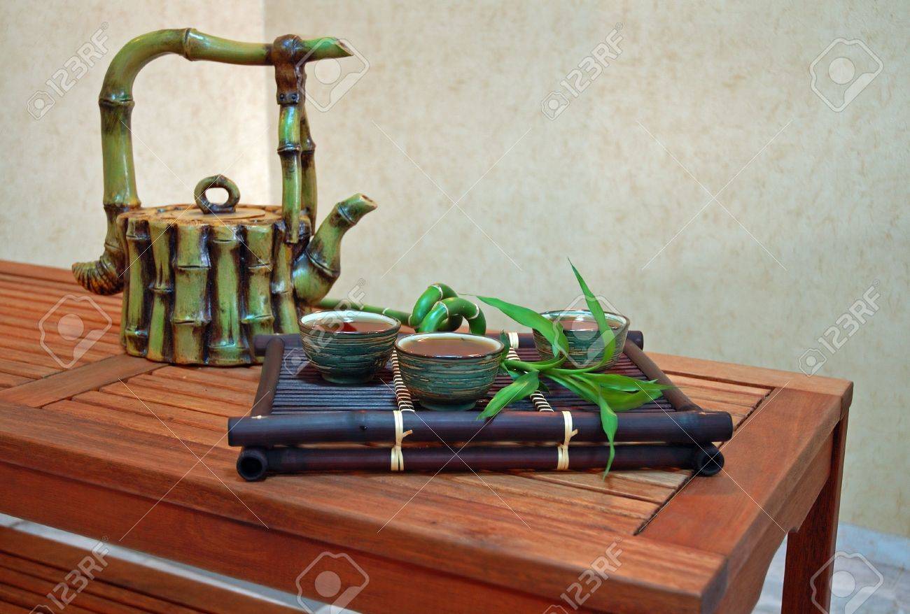 chinese tea in antique bowls with bamboo and teapot. interior chinese tea in antique bowls with bamboo and teapot. interior